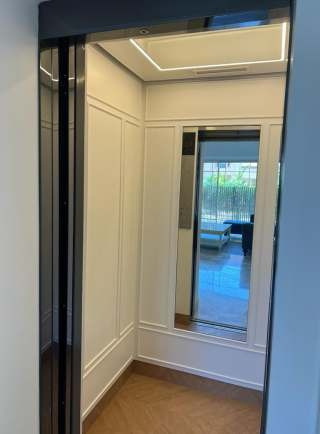 Stainless steel elevator cabin with golden floor