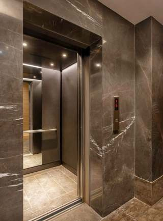 Elevator cabin with marble wall finish